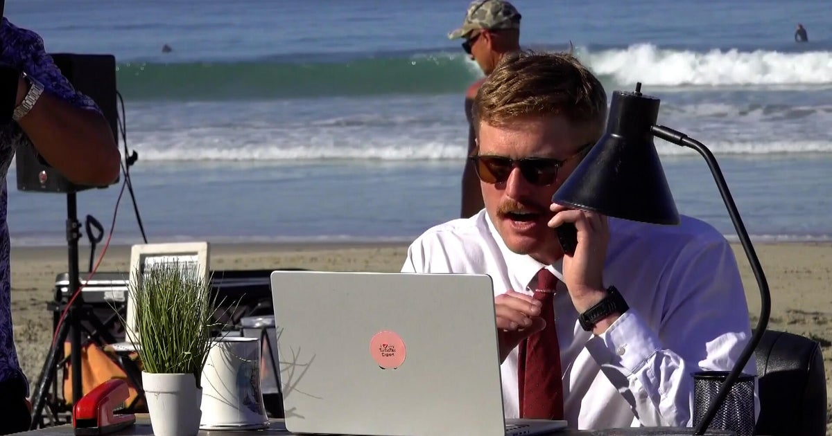 Man embraces remote work by setting up offices at the beach, baseball game