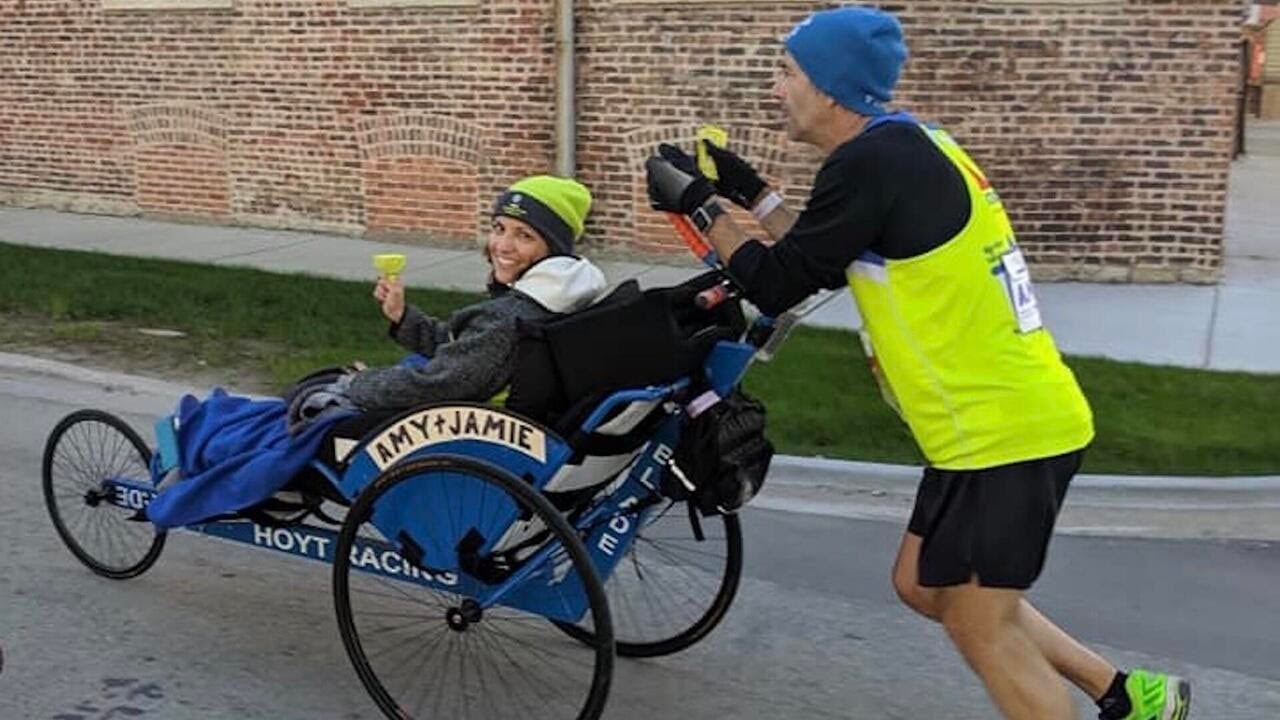 Couple teams up for their fifth marathon together: Him on foot, her on duo bike