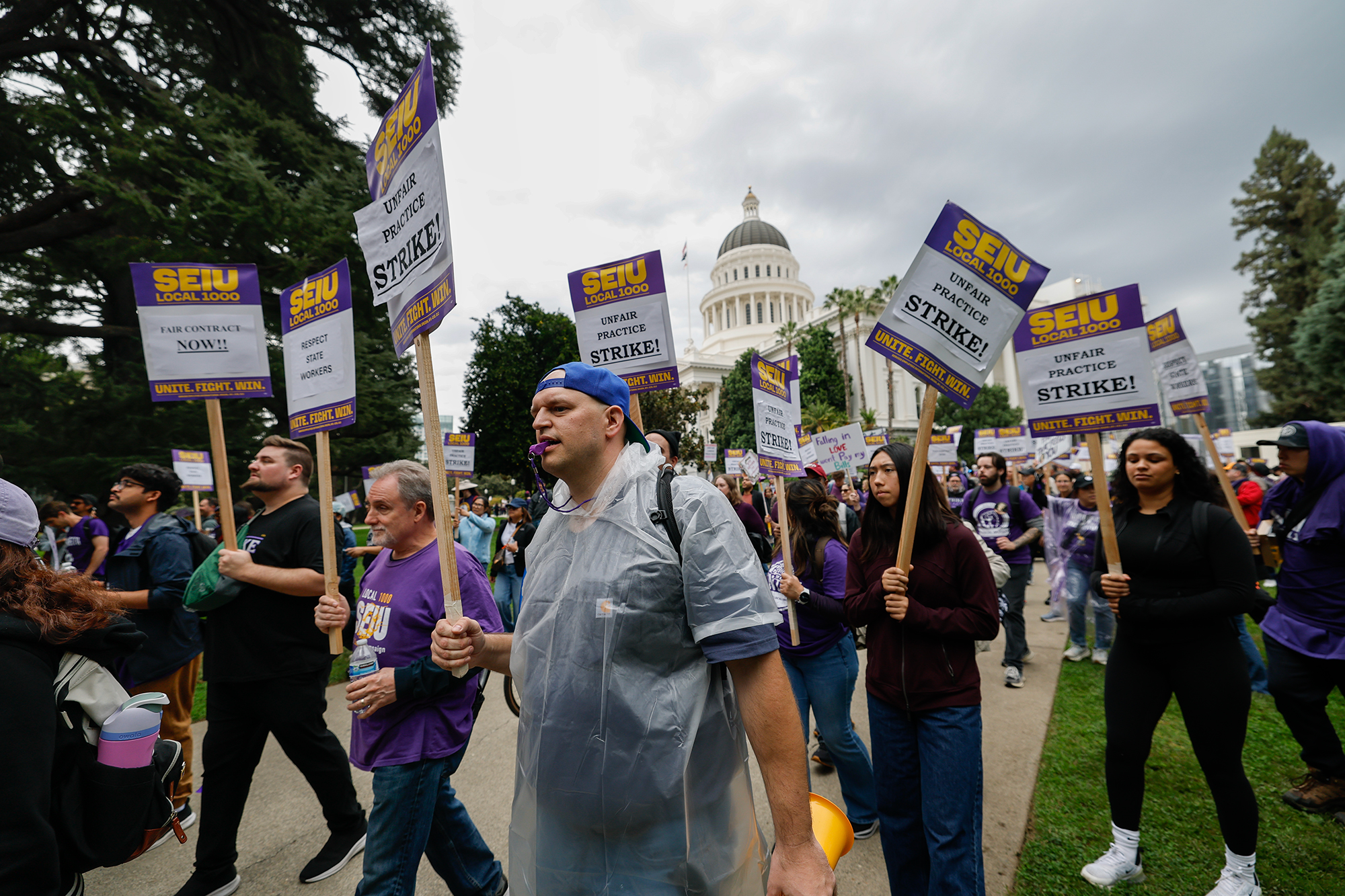 Thousands of California state workers walk off the job in contract dispute with Newsom – CalMatters
