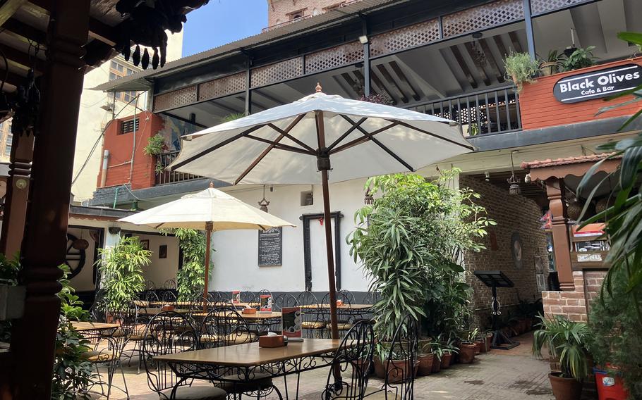 Buy time for lunch at Black Olives courtyard cafe in Kathmandu