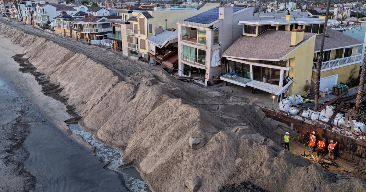 Photos show record-breaking tides flooding homes, roads in California